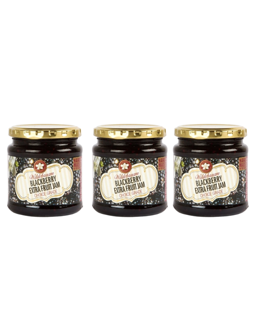 Three jars of blackberry extra fruit jam with gold lids on a white background
