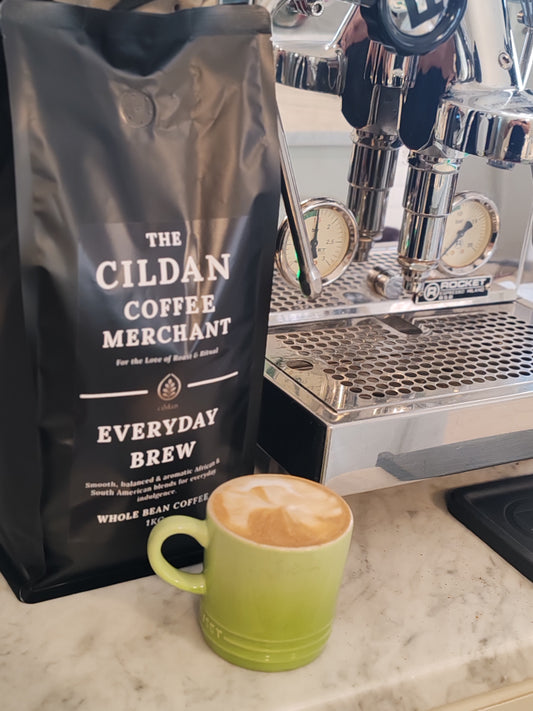 Cildan Coffee Merchant bag and green mug with coffee on a counter