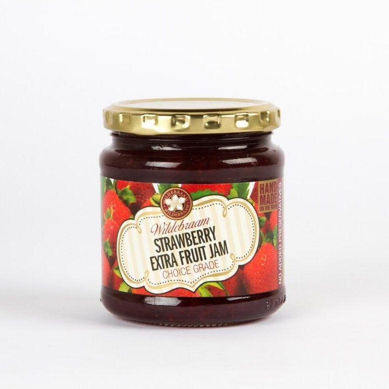 Jar of strawberry extra fruit jam with a gold lid on a white background