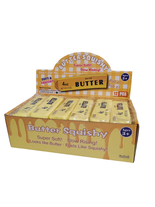 A retail display box of Butter Squishy slow-rising butter candies, showing multiple individual wrapped units inside a yellow and white gingham-themed box with 'Butter Squishy' printed on the front.