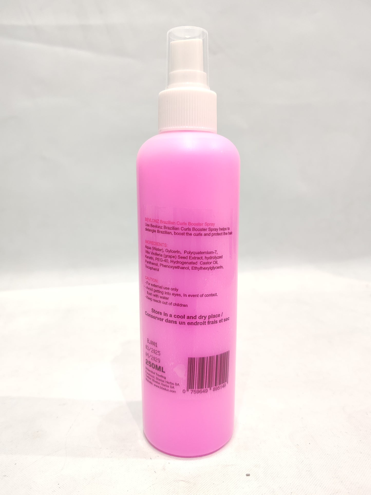 Pink spray bottle with a white nozzle on a light gray background
