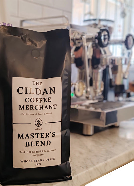 Black coffee bag labeled 'The Cildan Coffee Merchant Master's Blend' on a counter.