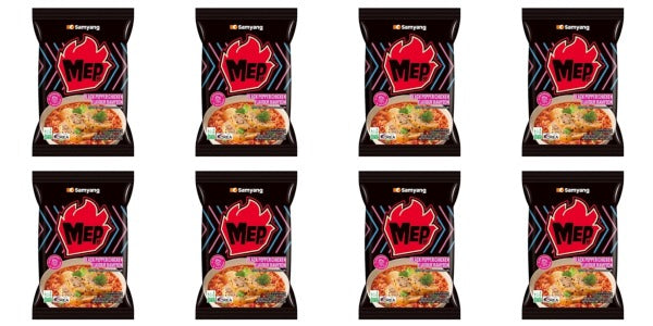 Multiple packages of Mie noodles with a red logo on a black background